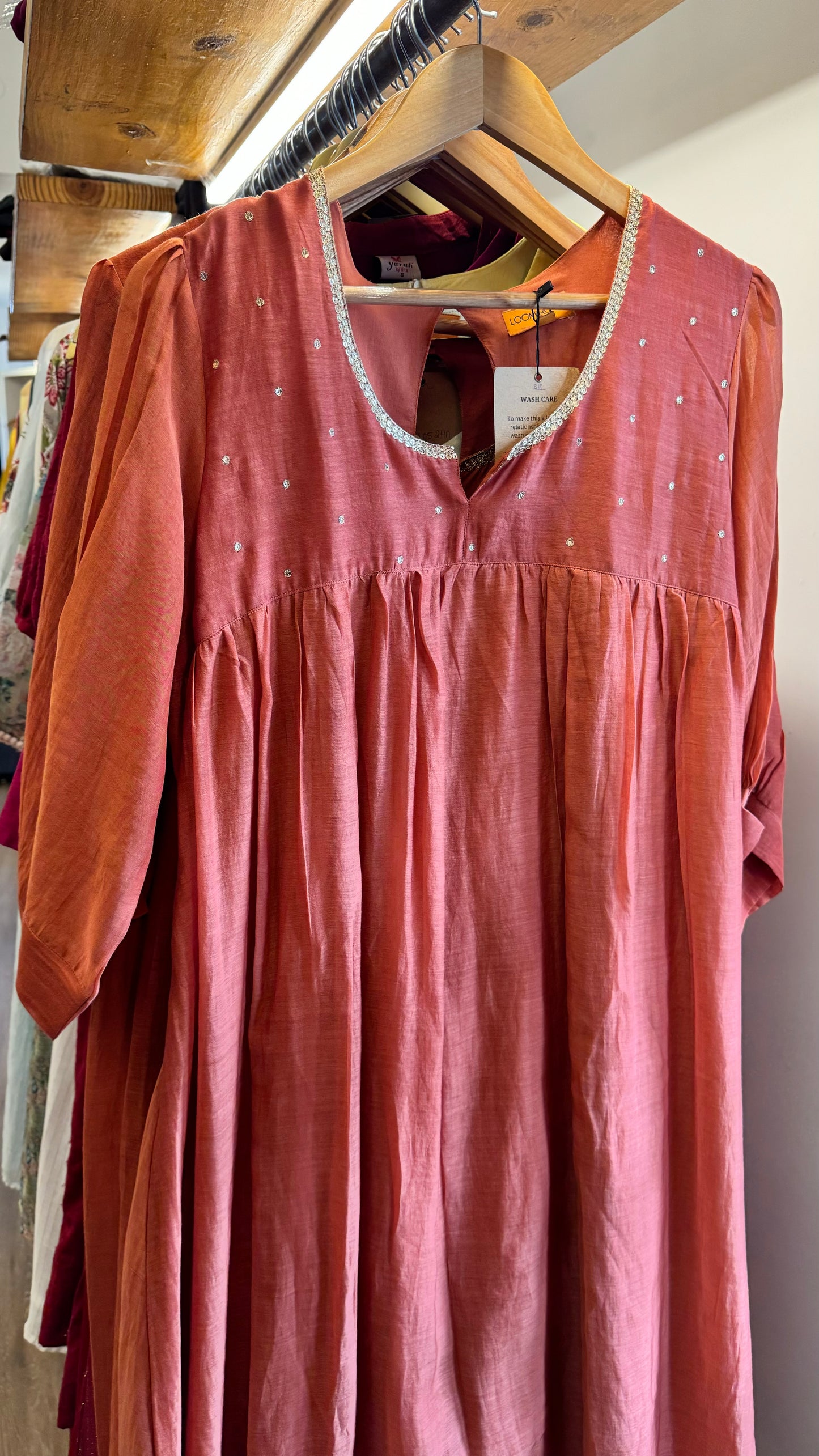 Carrot orange mul chanderi dress with golden sequins work on neckline and buttes on yoke and pleated sleeves