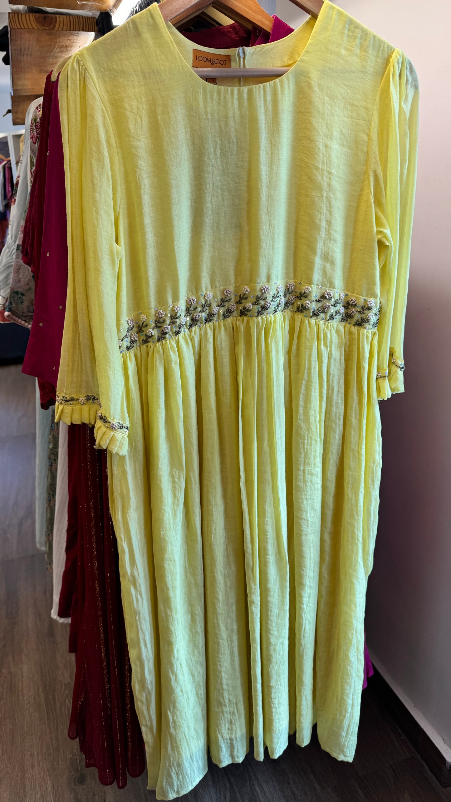 Bright yellow handwoven mul chanderi dress with floral embroidery on yoke line and sleeve ends