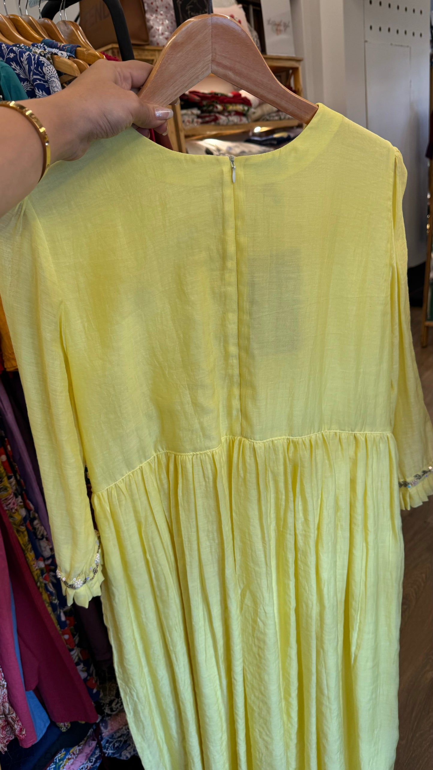 Bright yellow handwoven mul chanderi dress with floral embroidery on yoke line and sleeve ends