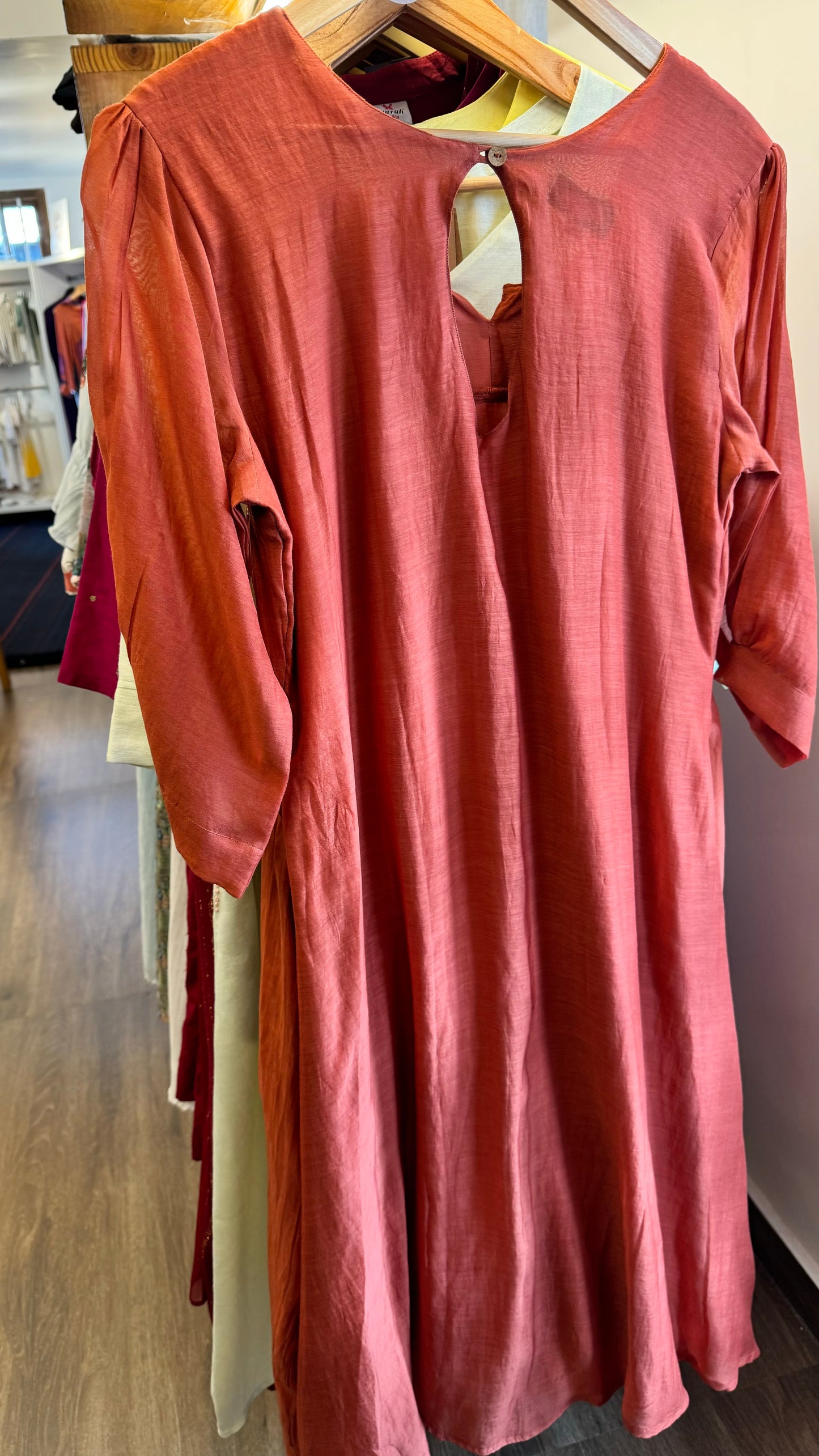 Carrot orange mul chanderi  dress with golden sequins work on neckline and buttes on yoke and pleated sleeves