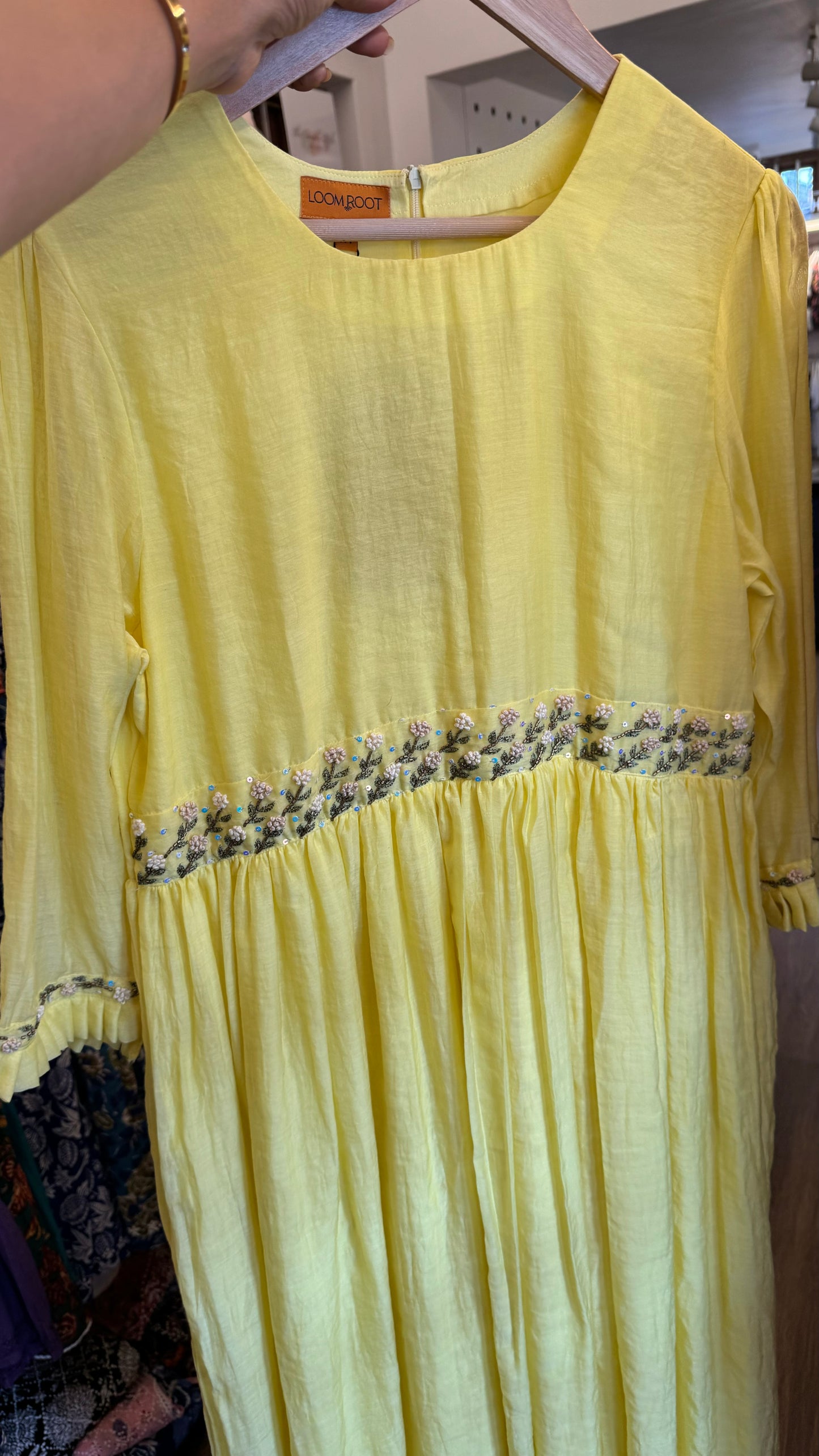 Bright yellow handwoven mul chanderi dress with floral embroidery on yoke line and sleeve ends