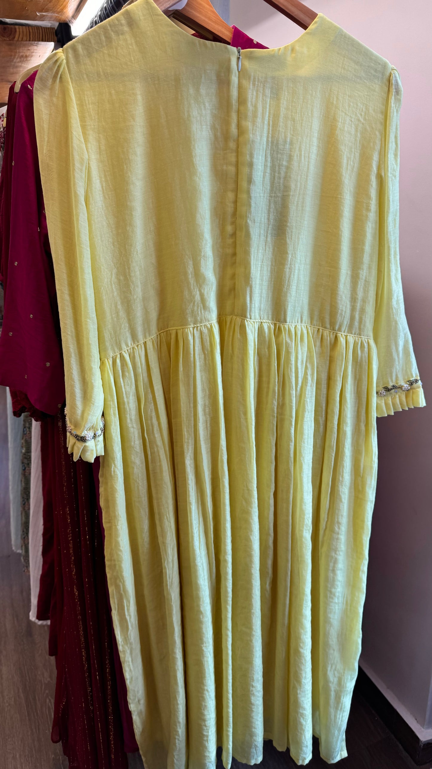 Bright yellow handwoven mul chanderi dress with floral embroidery on yoke line and sleeve ends