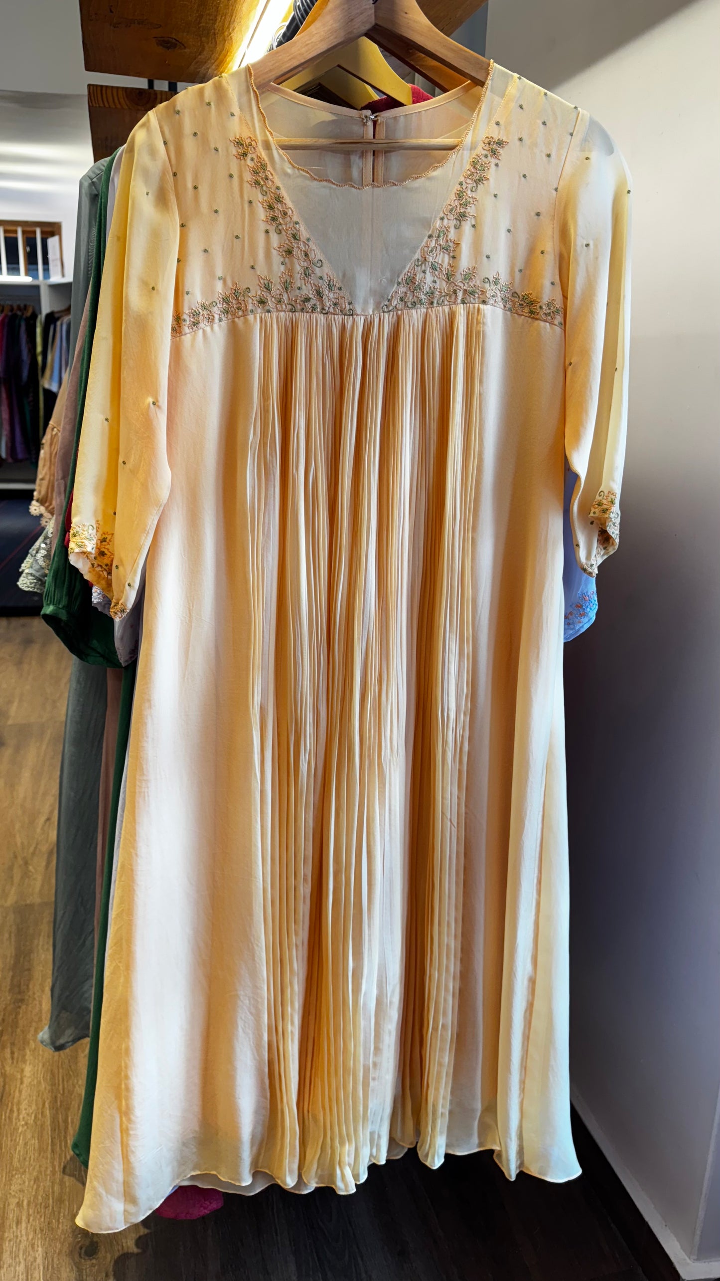 Dark cream colour embroidered yoke with a v neckline and pleated front size M