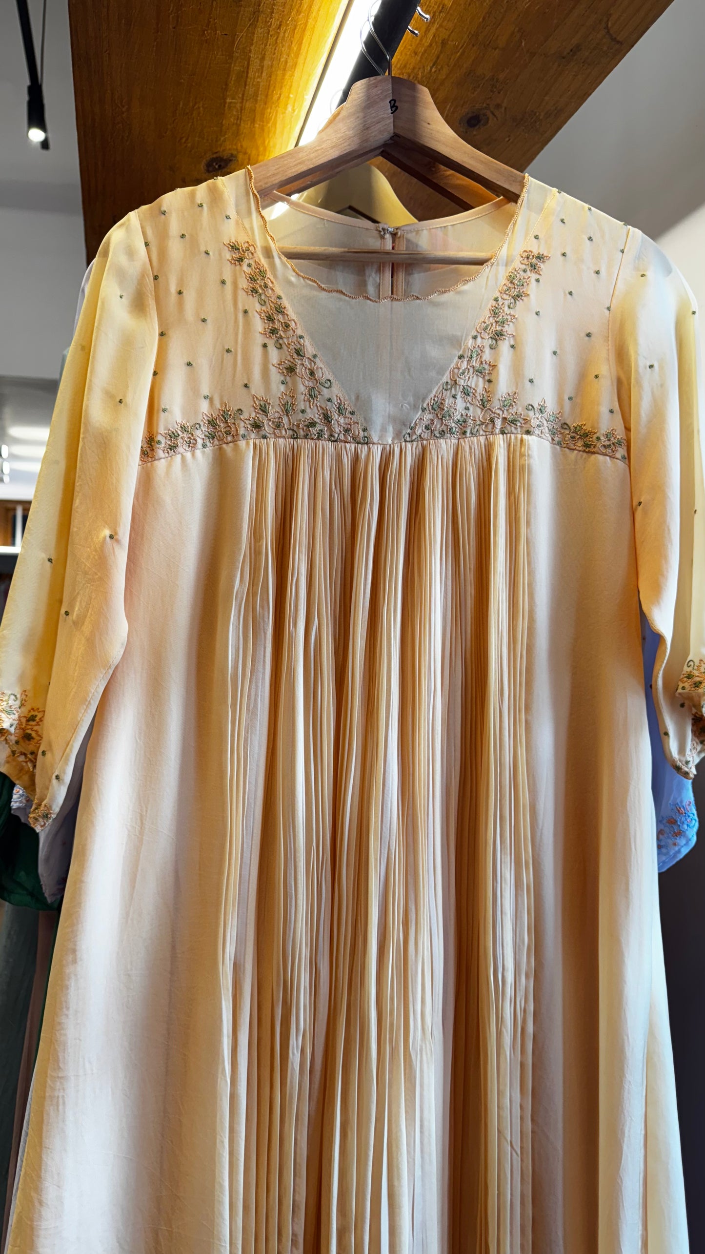 Dark cream colour embroidered yoke with a v neckline and pleated front size M