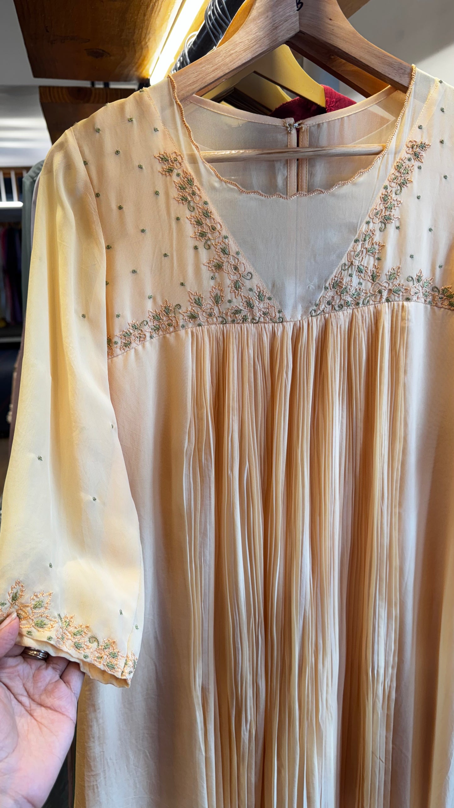 Dark cream colour embroidered yoke with a v neckline and pleated front size M