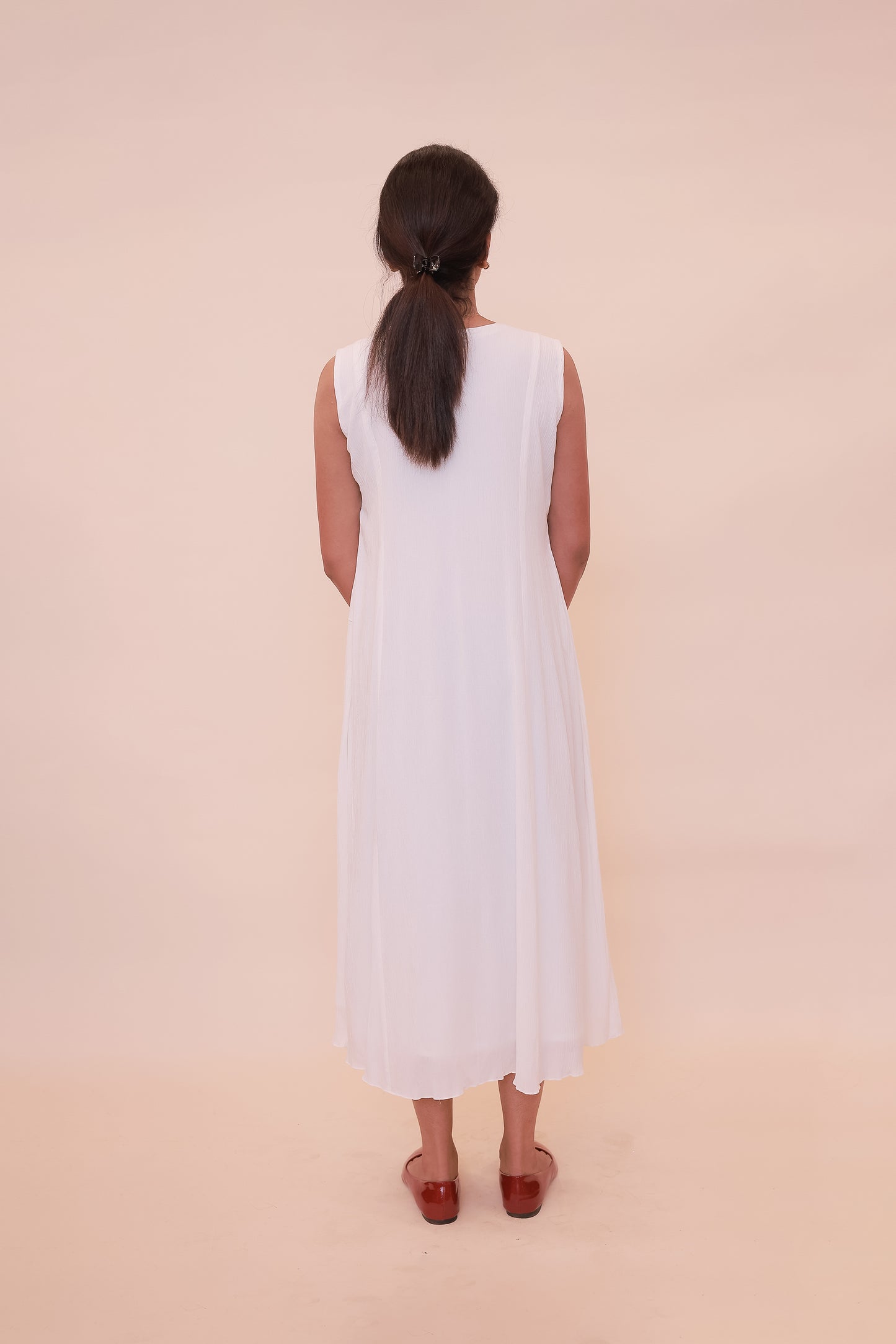 White sleeveless with embroidery on neck